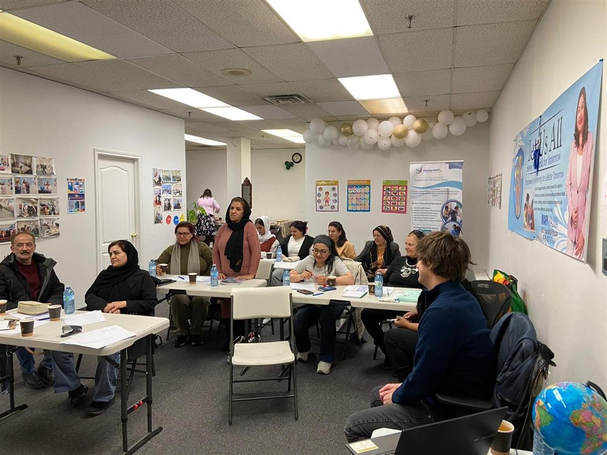 Participants at a free English class workshop at the WakeUp Health hub